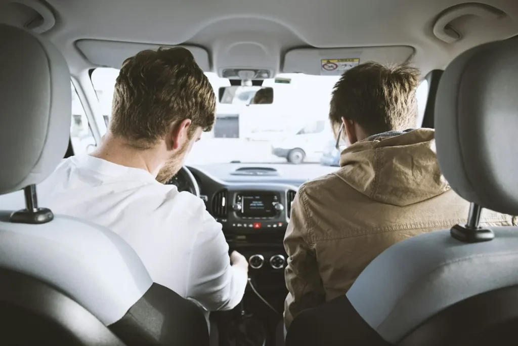 Instructor and student driver in the front seats of a car
